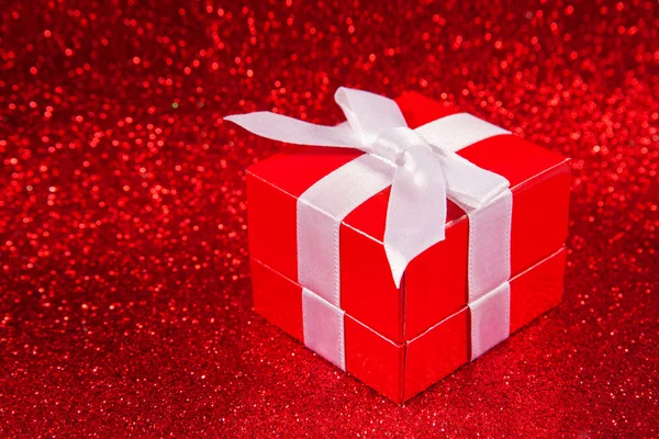 Red gift boxes on glitter red background — Stock Photo, Image