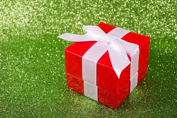 Christmas gift against a magical glitter shiny background with copy space. — Stock Photo, Image