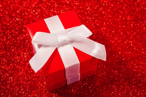 Red gift boxes on glitter red background — Stock Photo, Image