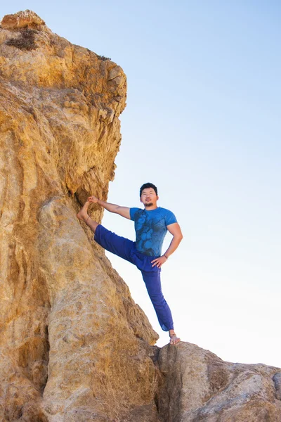 Hombre asiático medita en posición de yoga en altas montañas por encima del cielo azul . —  Fotos de Stock