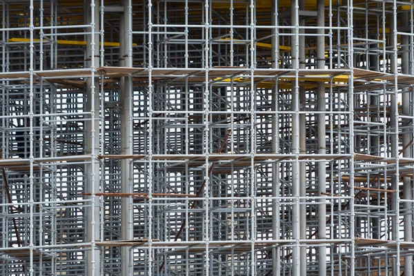 View of scaffolding and structural reinforcement during the construction of a round building