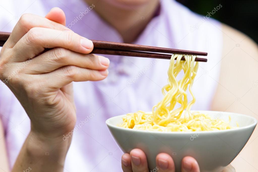 Woman eating noodle