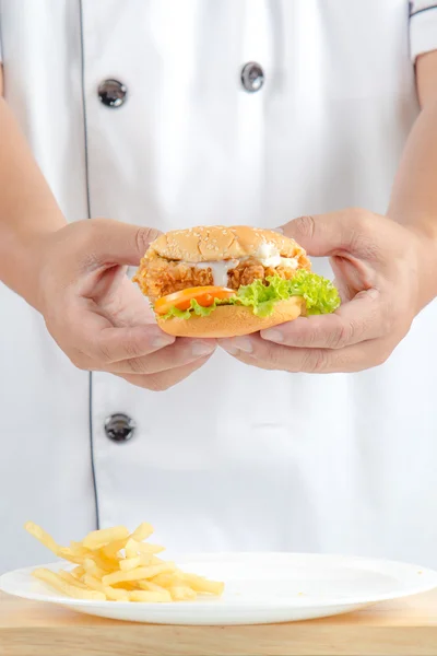 Chef segurando hambúrguer de frango frito — Fotografia de Stock