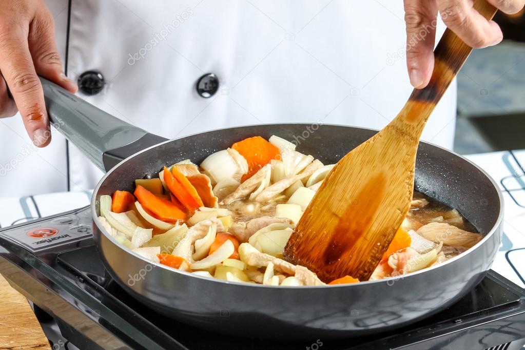 Chef cooking stir fry vegetables