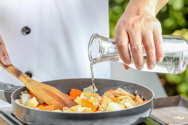 Chef pouring  oil — Stock Photo, Image