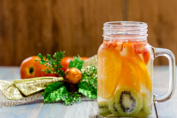 Citrus fruits and kiwi, tomato in pitcher — Stock Photo, Image