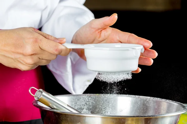 Chef sifting flour — Stock Photo, Image