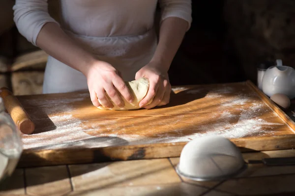 テーブルの上で小麦粉で生地をこねるベイカー手 — ストック写真