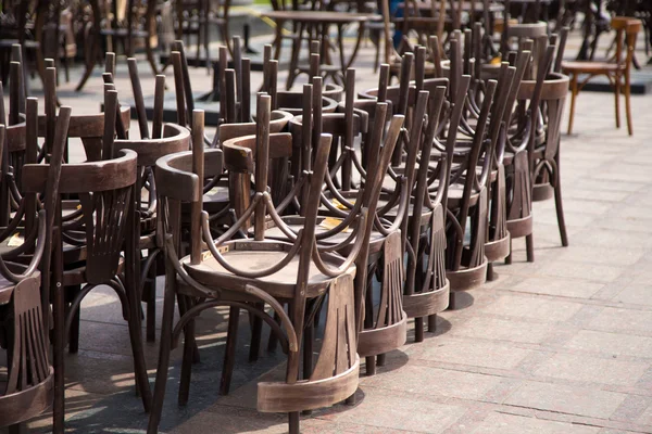 old wooden chairs and vintage chairs, one on the street