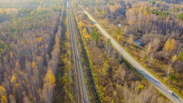 Russia, Ural, Yekaterinburg. Railway train with wagons. Electrified Railway. Highway. Sunset light, Aerial View