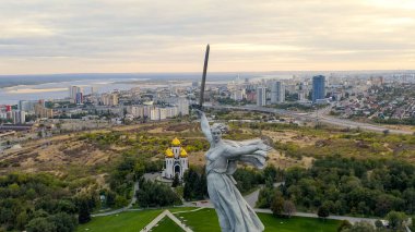 Volgograd, Russia. Evening view of the sculpture Motherland Calls! on the Mamaev Kurgan in Volgograd. Cloudy weather, Aerial View   clipart