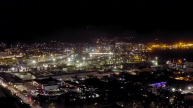 Novorossiysk, Rusya. Geceleyin Novorossiysk Limanı. Gece şehir ışıkları. Karadeniz 'deki Tsemesskaya Körfezi. 4K