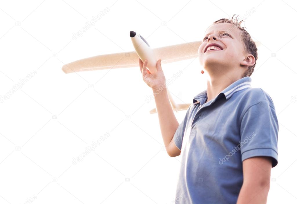 Boy looking at the sky with a plane