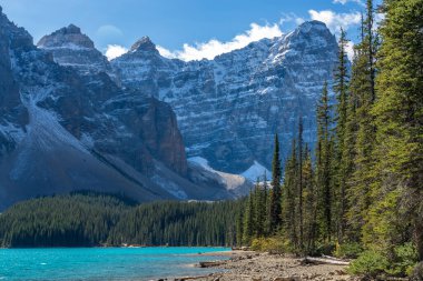 Moraine Gölü. Güneşli yaz sabahında güzel bir manzara. Işıltılı turkuaz mavi su, karla kaplı On Tepe Vadisi. Banff Ulusal Parkı, Kanada Kayalıkları, Alberta, Kanada