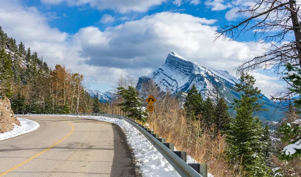 Snow-covered Mount Rundle with snowy forest mountain road. Mount Norquay Scenic Drive. Banff National Park beautiful landscape in winter. Canadian Rockies, Alberta, Canada.