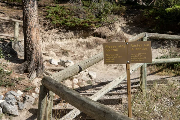 Stay on trail sign signpost at Tunnel Mountain Trail. Banff National Park, Canadian Rockies.