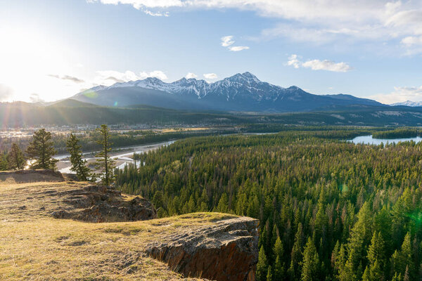 Jasper, Alberta, Canada - May 1 2021 : Canadian National Railway freight train. Canadian Rockies, Jasper National Park.
