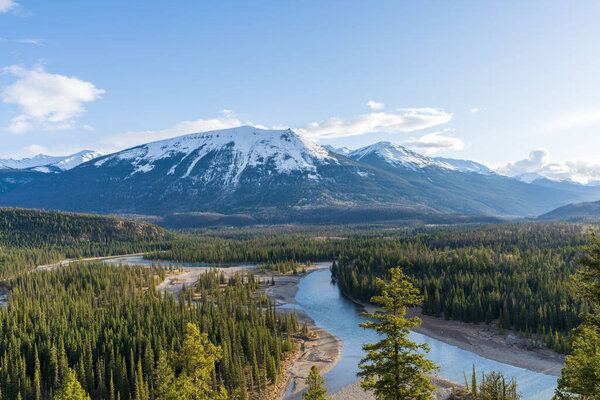 Jasper, Alberta, Canada - May 1 2021 : Canadian National Railway freight train. Canadian Rockies, Jasper National Park.