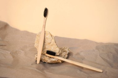 Composition of natural details and a bamboo toothbrush on beige background. Zero watse concept. clipart