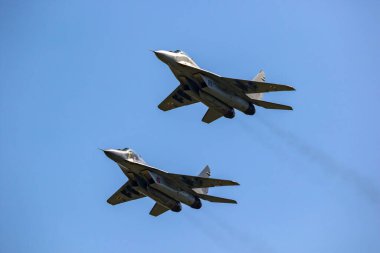 MiG-29 Fulcrum fighter jets of the Polish Air Force in flight over Florennes Air Base, Belgium - June 15, 201 clipart