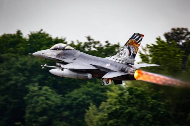 Portuguese Air Force F-16 fighter jet taking off with afterburner from Mont-de-Marsan airbase during the NATO Tigermeet. Mont-De-Marsan, France - May 17, 2019. clipart