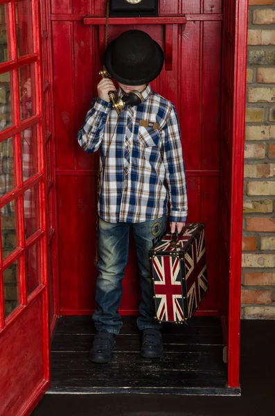 Boy in London phone box — Stock Photo, Image