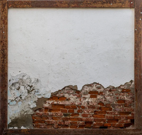 Peeled plaster with brick and frame Stock Image