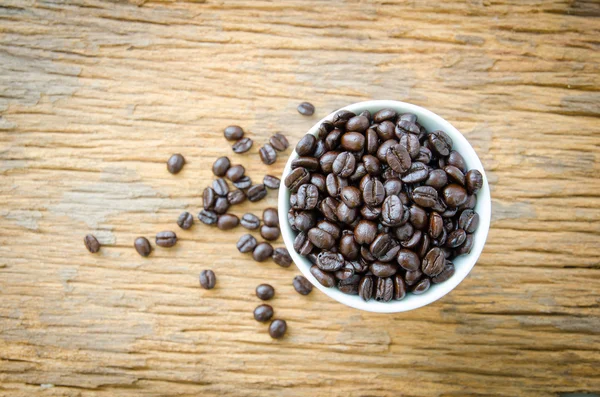 Coffee beans on  cup of wooden background — Stock Photo, Image