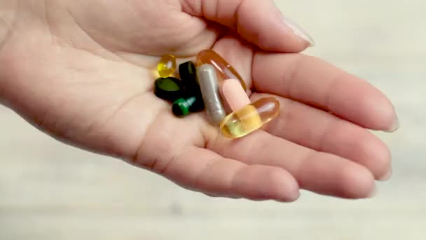 Different pills in hand, dietary supplements. selective focus — Stock Video