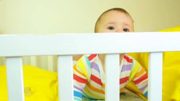 Baby plays in the crib. selective focus. — Stock Video