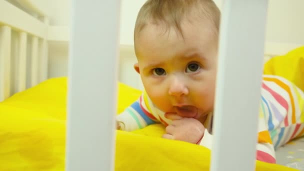 Baby plays in the crib. selective focus. — Stock Video