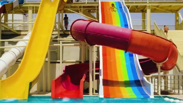 A child descends from the water park slides. selective focus. — Stock Video