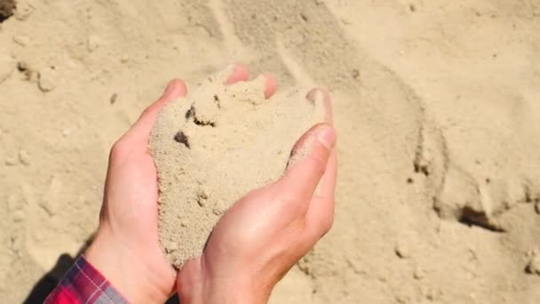 Ein Mann hält einen Sandverkauf in der Hand. Selektiver Fokus. — Stockvideo