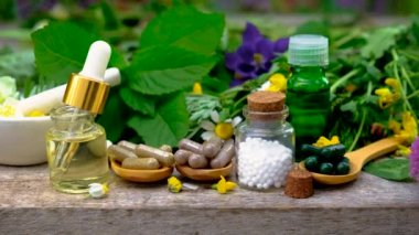 Homeopati, küçük bir şişedeki şifalı bitkilerin tentürü. Seçici odak.