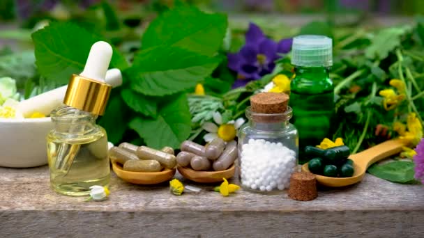 Homeopathy is a tincture of medicinal herbs in a small bottle. Selective focus. — Stock Video