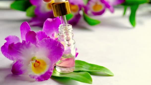 Orchid essential oil in a small bottle. Selective focus. — Stock Video