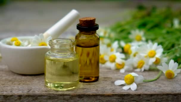 Chamomile extract in a small bottle. Selective focus. — Stock Video