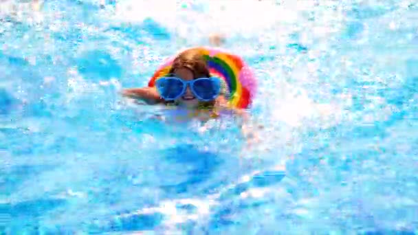 L'enfant nage dans un cercle dans la piscine. Concentration sélective. — Video