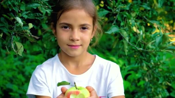 Das Kind isst im Garten einen Apfel. Selektiver Fokus. — Stockvideo