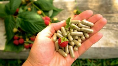 Raspberry leaf extract and supplements. Selective focus. Food.