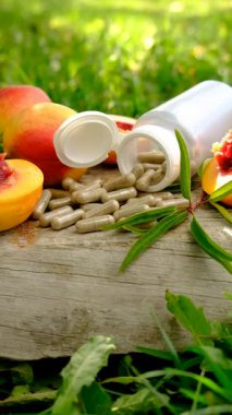 Peach kernel oil and supplements. Selective focus. nature.