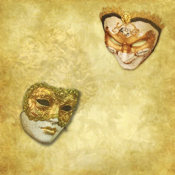 Two Venetian masks on a rich golden textured background — Stock Photo, Image