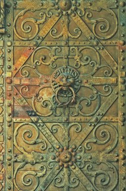 Medieval bronze gate with elaborated door knocker clipart