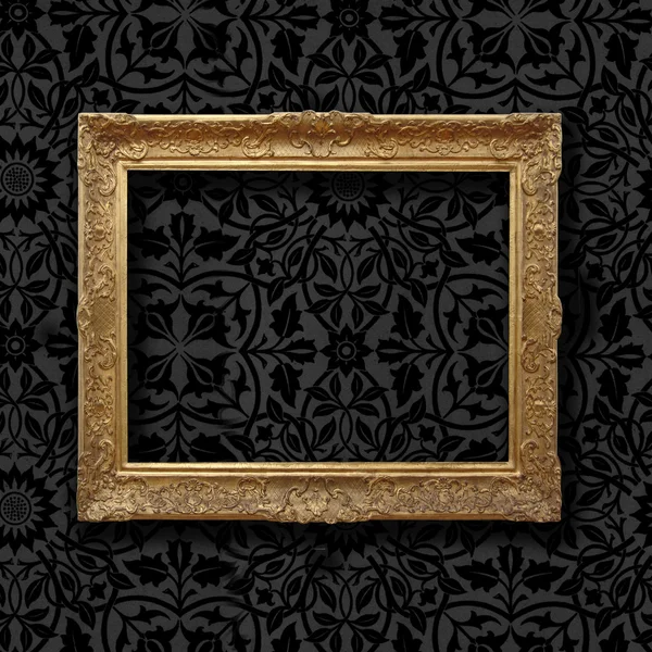 Vintage golden frame on black floral velvet wallpaper — Stock Photo, Image