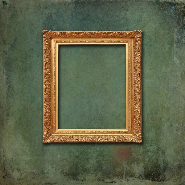 Gold baroque frame on a green grunge wall — Stock Photo, Image