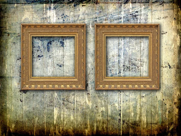 Two golden frames on grunge  wood wall — Stock Photo, Image