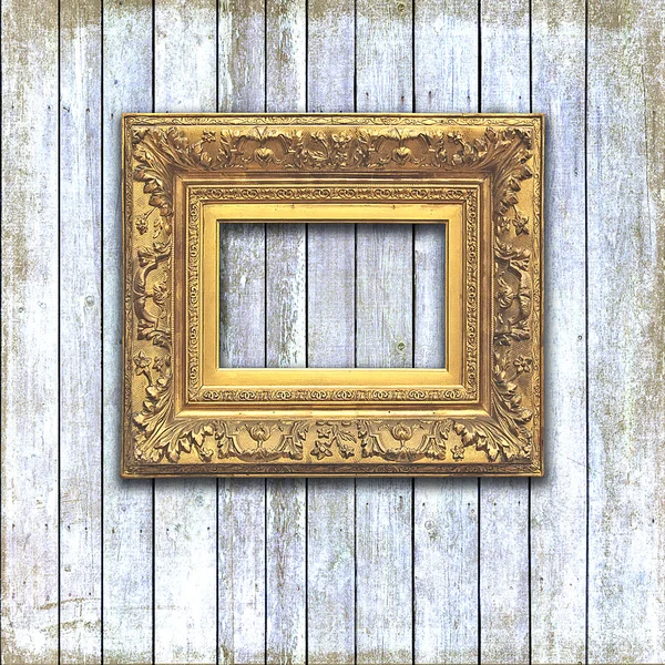 Golden frame on a bleached wood plack wall — Stock Photo, Image