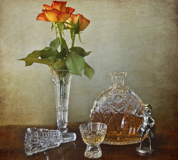 Garrafa de cristal de conhaque com rosas — Fotografia de Stock