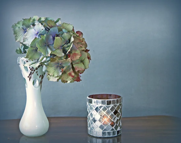 Hydrangea flower in vase and candle — Stock Photo, Image