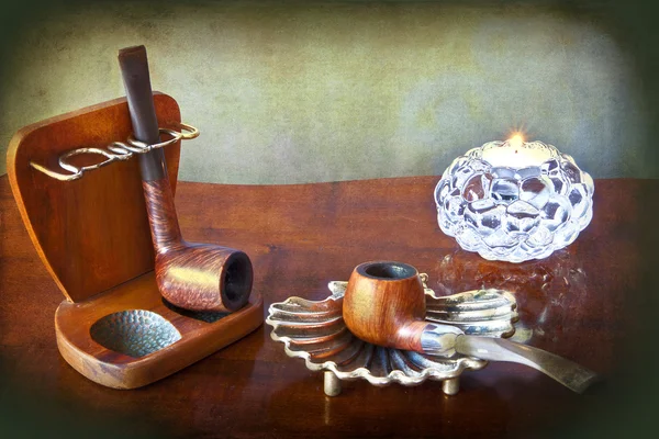 Grunge tobacco pipes and candle — Stock Photo, Image